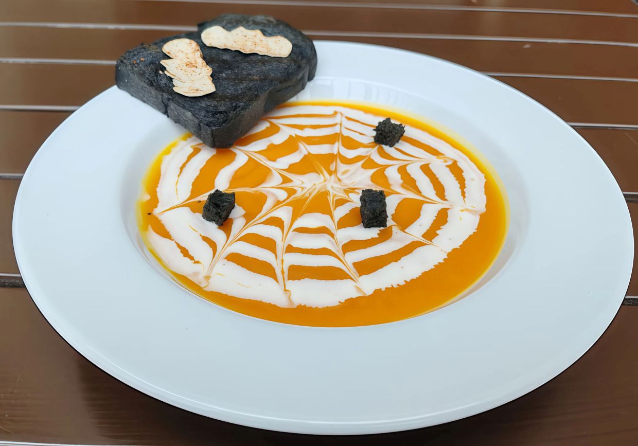 One of the Halloween treats you can try is the Spider Web Pumpkin Soup.
