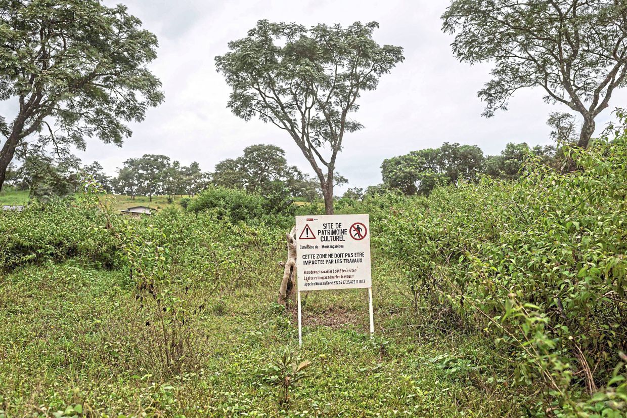 A sign near the mining project indicating the area as a cultural heritage site, forbidding any construction from taking place.