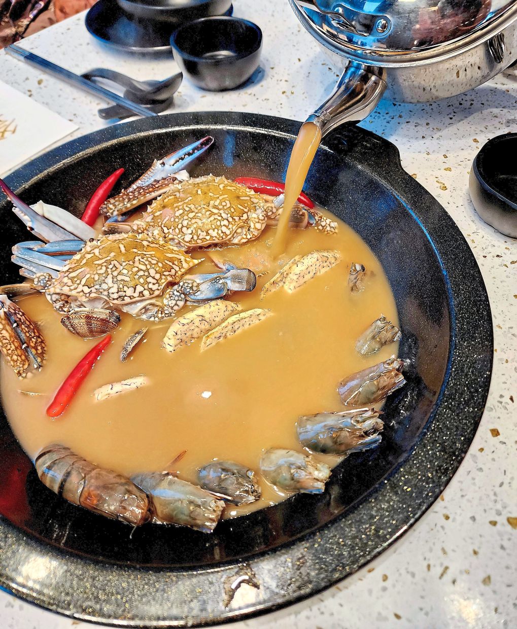 The broth that forms the base of the crab king pot is fashioned out of pork bones and about 12 other ingredients that are cooked together for eight hours. — ABIRAMI DURAI/The Star