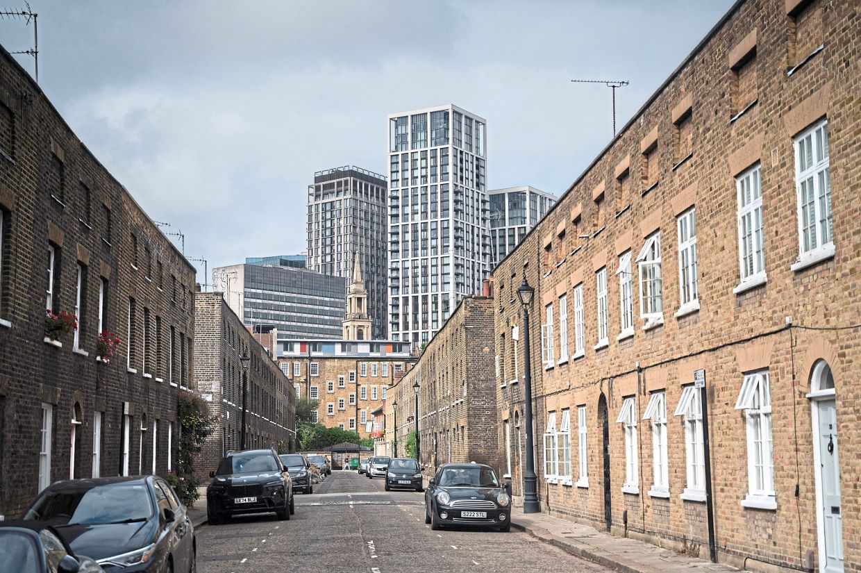 Modern tower blocks are pictured behind the 1820’s Roupell Street Conservation Area in London.