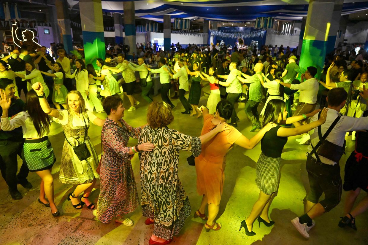 People dancing during the Oktoberfest in Phnom Penh on Oct 24, 2025. - AFP