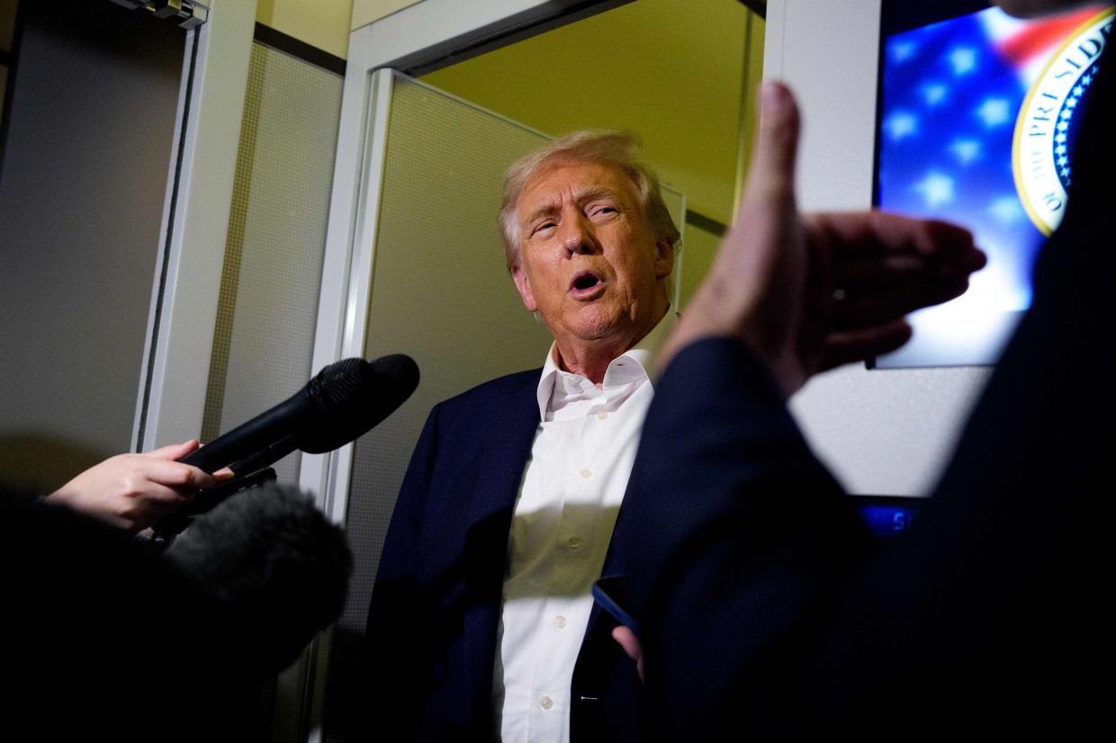 IN FLIGHT: President Donald Trump speaks to members of the media aboard Air Force One in flight. Trump is traveling to Malaysia for the Association of Southeast Asian Nations summit (Asean), Japan, and to South Korea for the Asia-Pacific Economic Cooperation forum (APEC). --Andrew Harnik/Getty Images/AFP