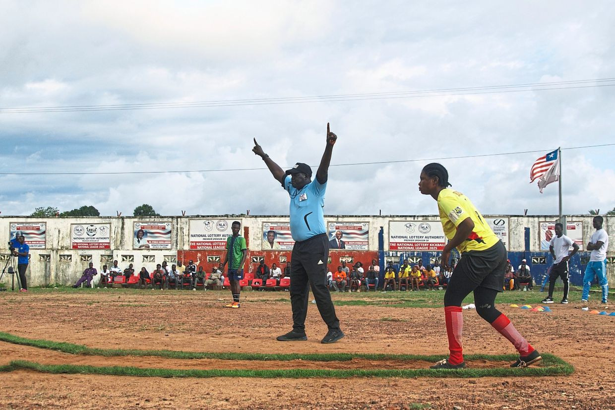 A kickball player prepares to kick the ball. — AP 