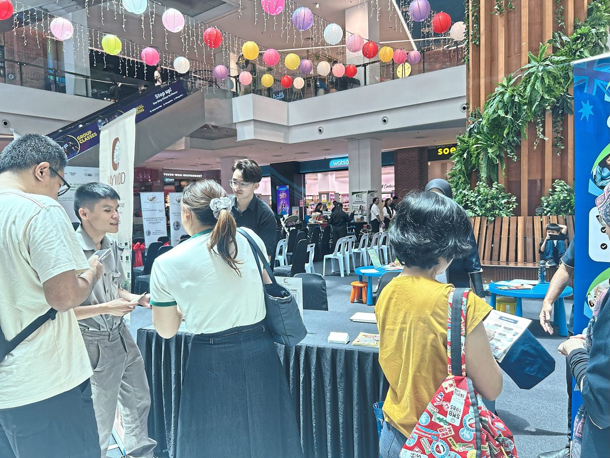 Visitors stopping by for information on well-being at the World Mental Health Day event in Petaling Jaya.