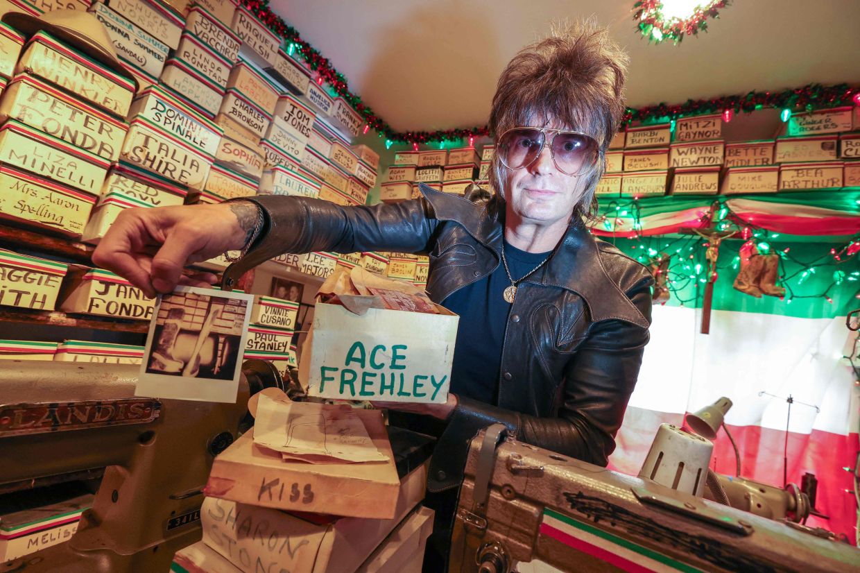 Shoemaker Chris Francis shows a photo of Kiss musician Ace Frehley's boots that were made by Pasquale Di Fabrizio, the shoemaker who made shoes for Hollywood stars from the 1960s to early 2000s. Photo: AFP