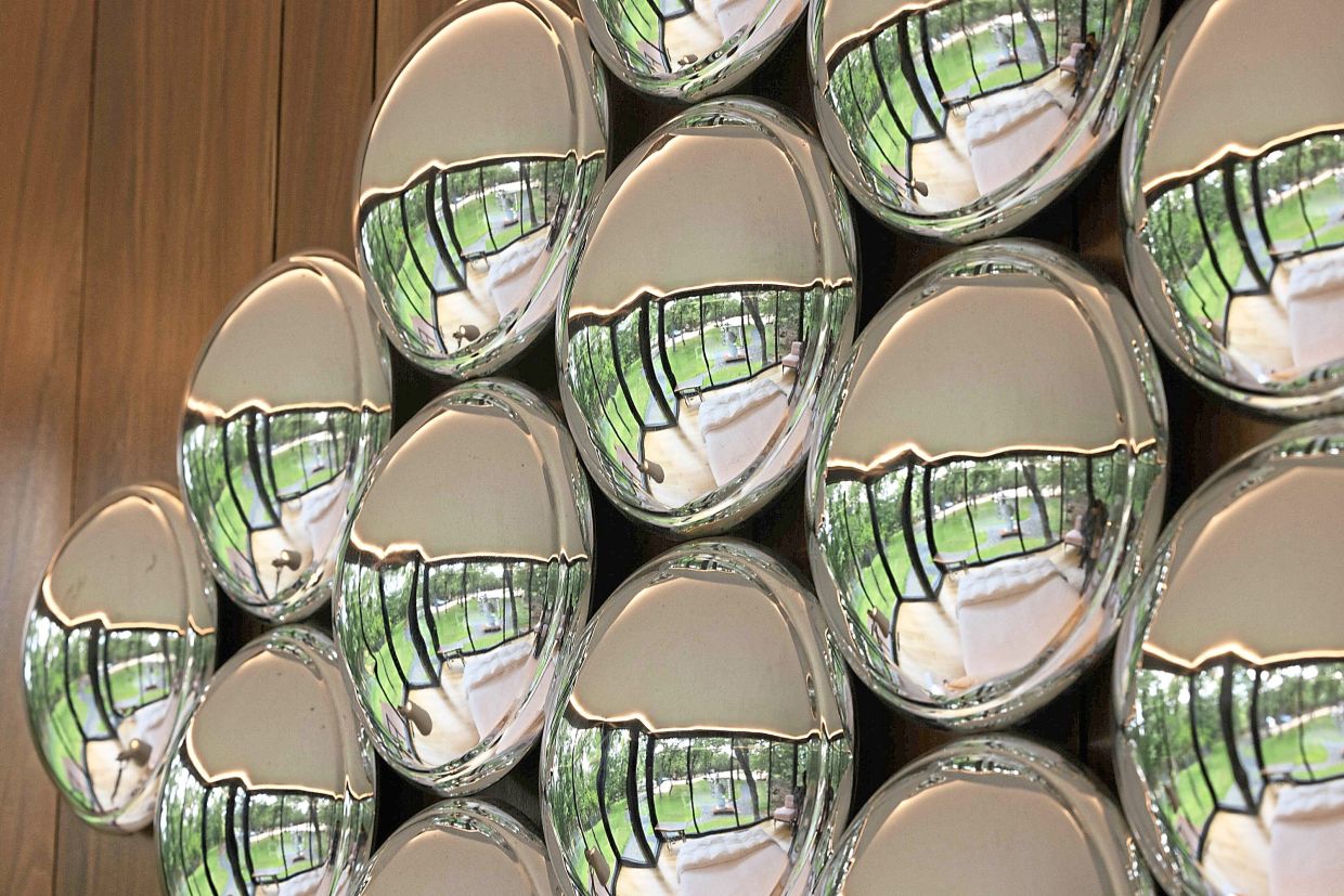 A sculpture of recycled hubcaps at the house.