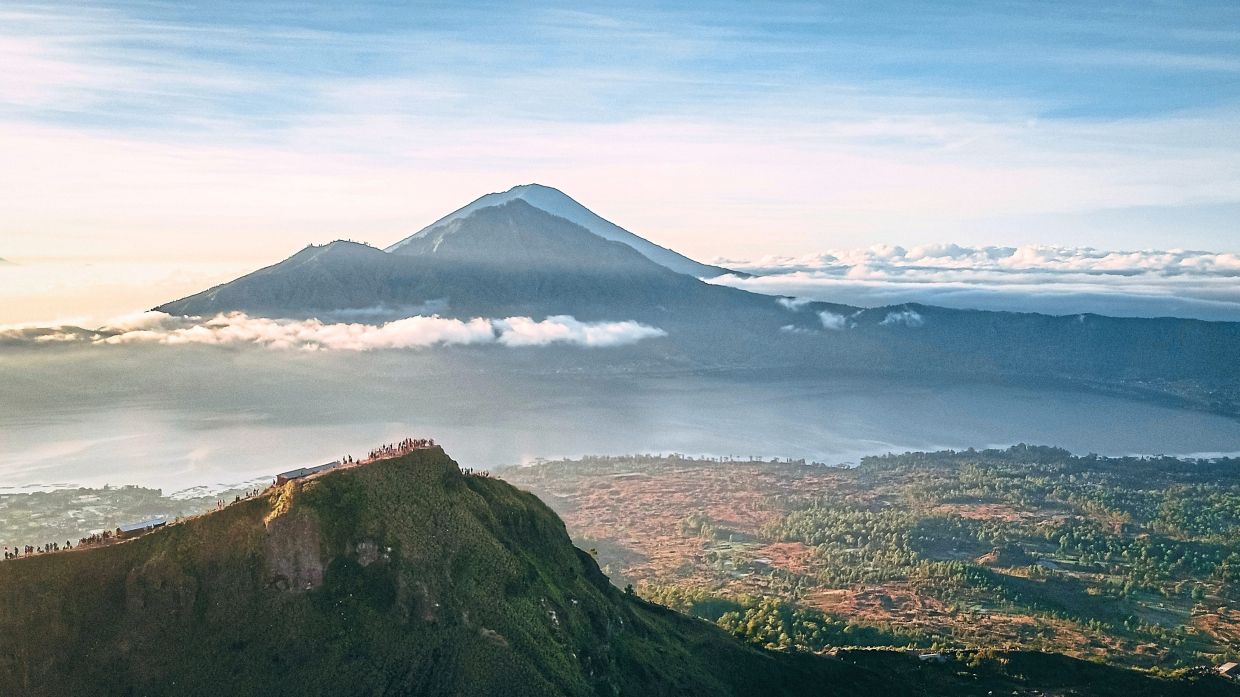 Catching the sunset at Mount Batur is a popular activity in Indonesia. — Unsplash