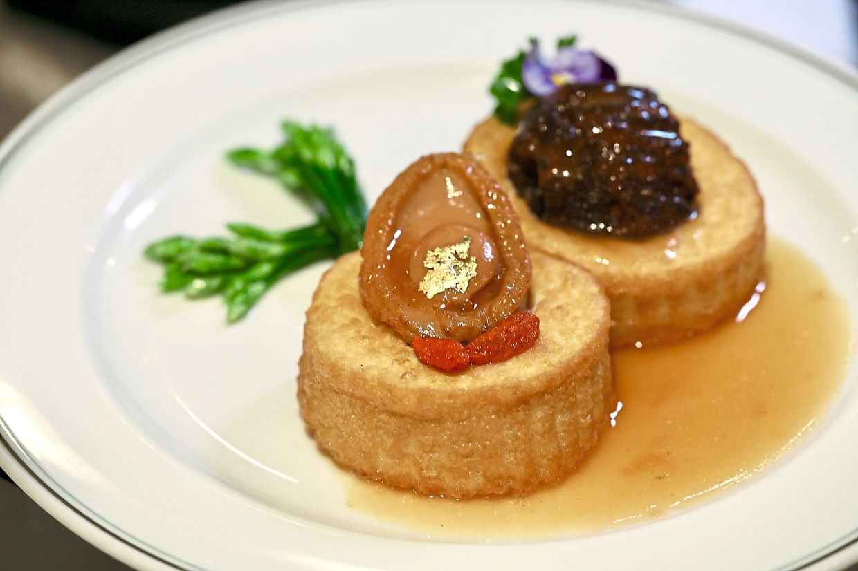 A luxury beancurd dish topped with a 10-head abalone and jumbo sea cucumber.