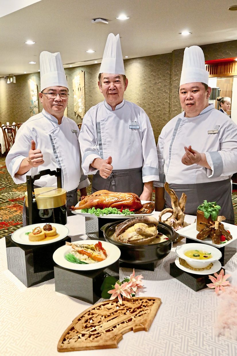 (From left) Sous chef Foong Yok Hon, Ah Kwai and Tok with delicacies from Xin Cuisine. Left: A close-up of the beancurd dish topped with 10-head abalone and jumbo sea cucumber.