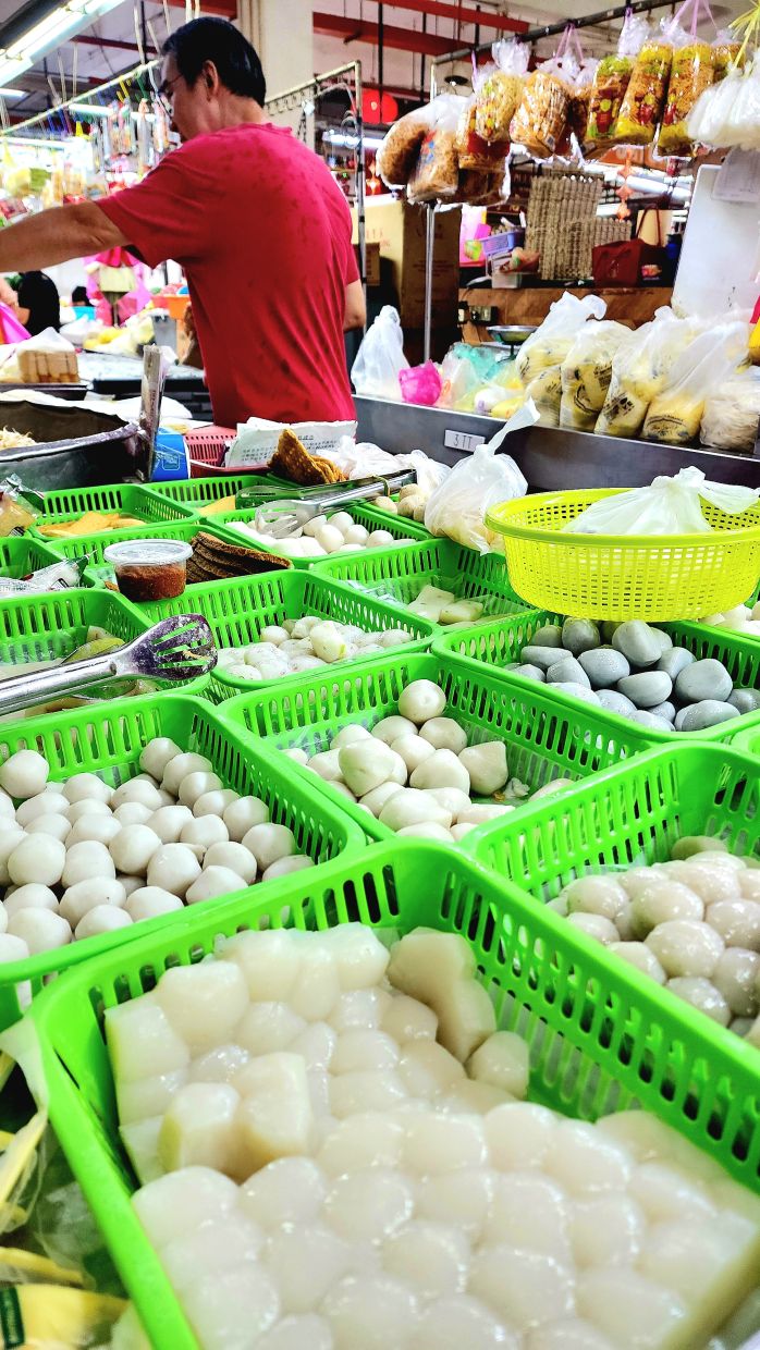 A wide variety of fresh fish balls at a stall in the Batu Lanchang market and (below) fresh tofu at the market, still warm to the touch. — ARNOLD LOH/The Star