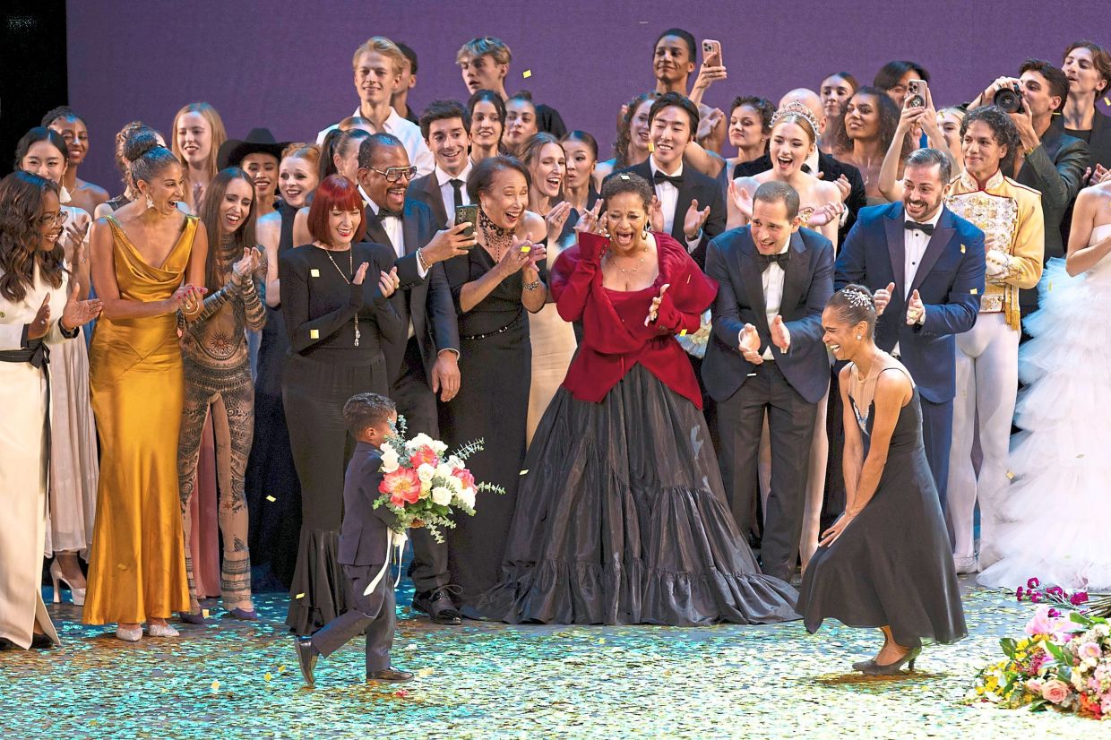 Copeland (right) takes a bow during curtain calls with her son, Jackson, at her retirement performance.