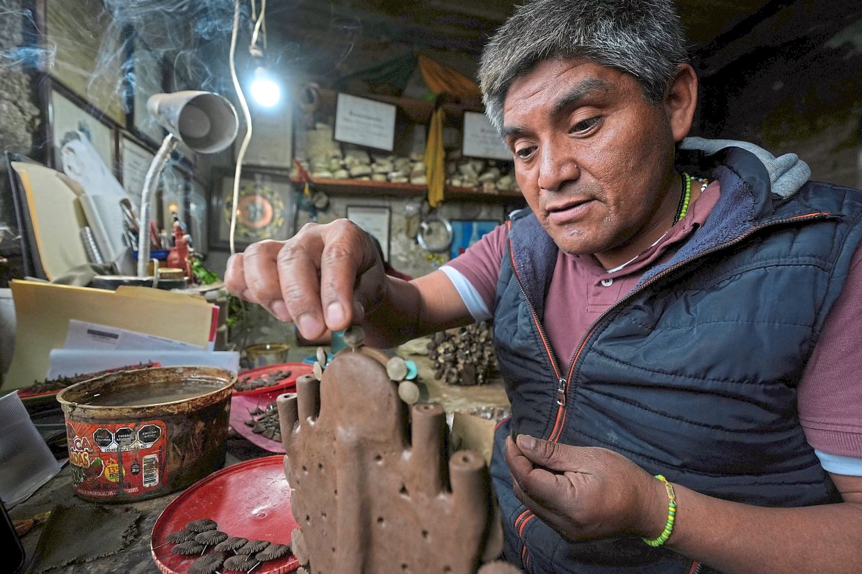 Hernandez works on a fragile clay piece at his workshop in Metepec, Mexico. — Photos: AP