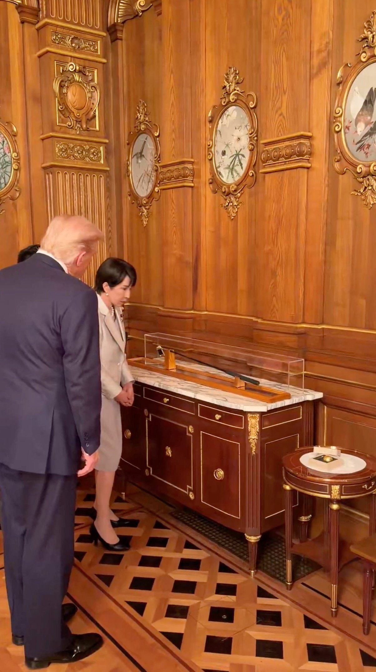 Takaichi gifting Trump a putter owned by late Prime Minister Shinzo Abe and a gold leaf golf ball in Tokyo on Oct 28, 2025 in this screen grab obtained from a handout video. - Margo Martin via X/Handout via Reuters