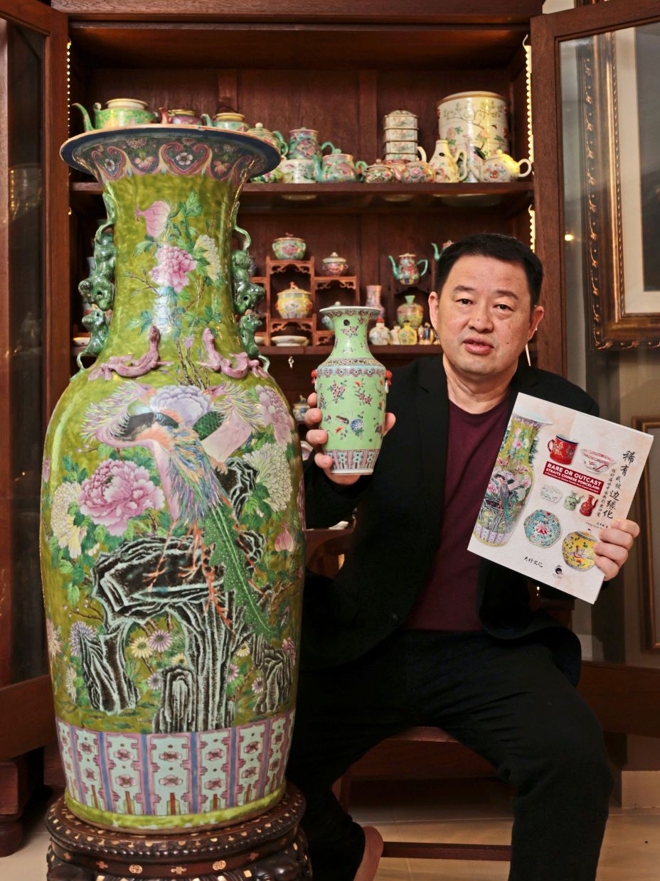 Chng posing with a copy of his book and some pieces from his treasured porcelain collection. — Photos: ZHAFARAN NASIB/The Star