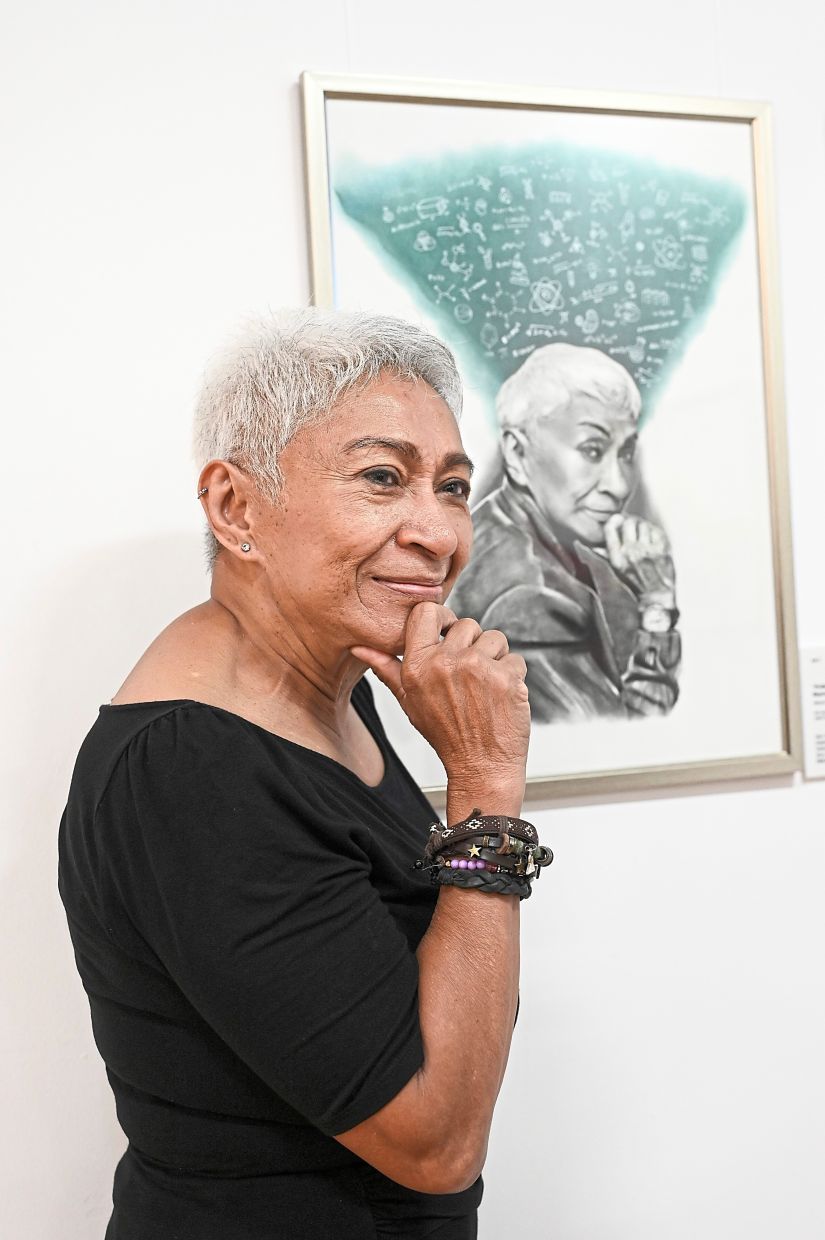 Mazlan posing next to her portrait.