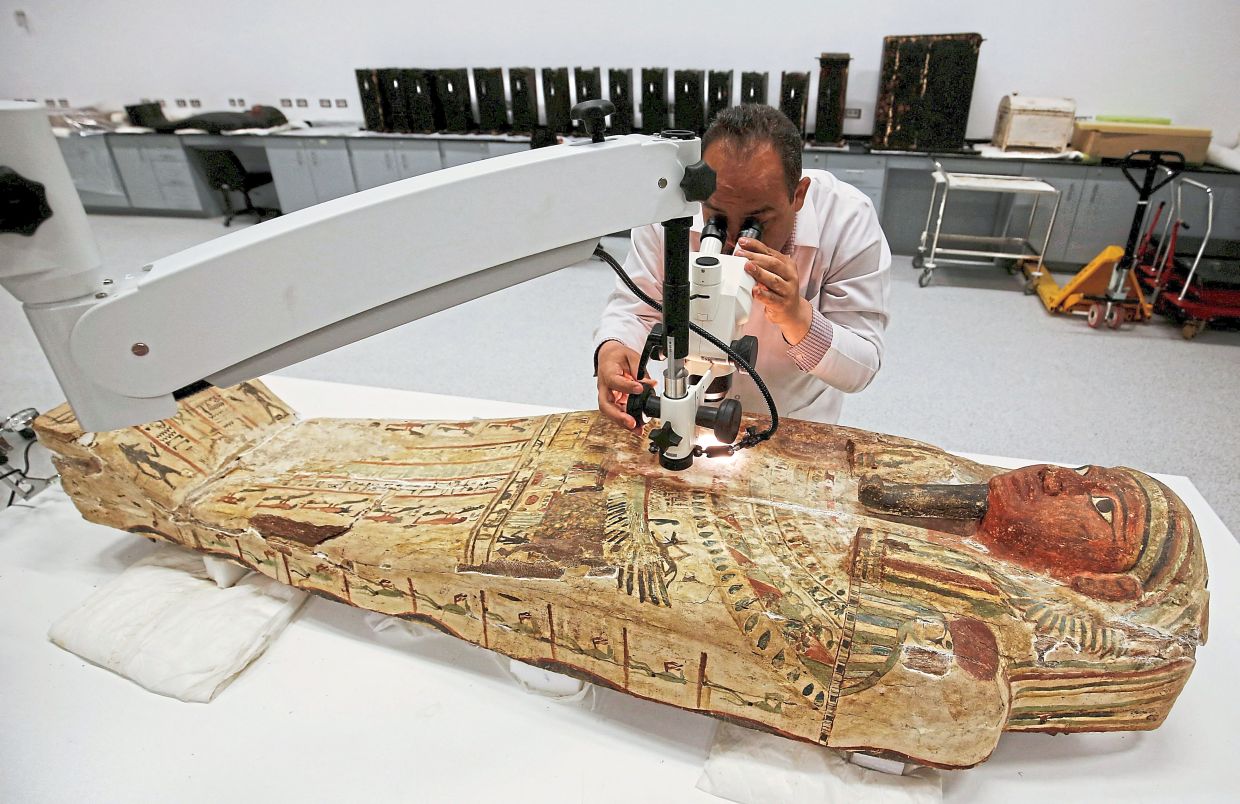 A file image of archaeologist Dr Medhat Abdallah working on a wooden sarcophagus in the Wood Laboratory of the conservation centre of Grand Egyptian Museum in August 2016. Photo: Reuters