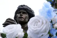 Soccer-Maradona statue rides through Naples as city remembers Argentine great