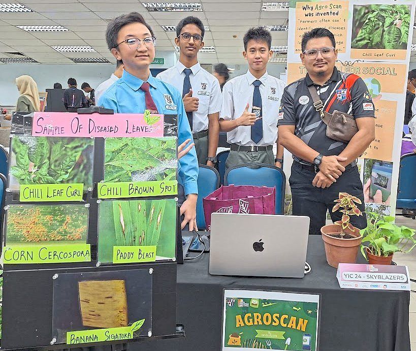 YIC: A teacher from SMK Tinggi St David posing for a photo with one of the teams that were awarded the gold medal.