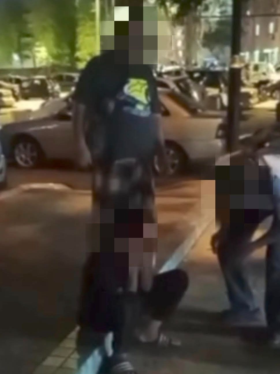 A screenshot from the video that went viral showing the three men attacking the 12-year-old boy.