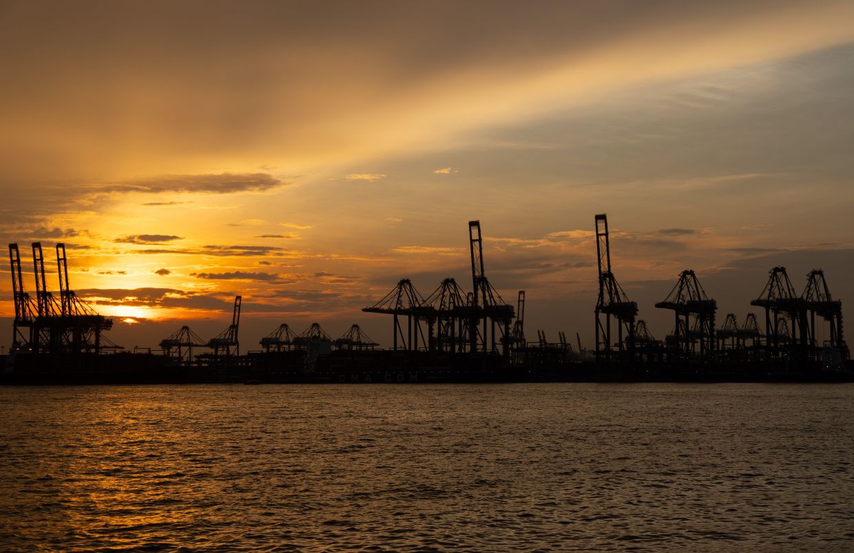 The sun sets over the Port of Singapore Authority's Pasir Panjang Terminal. -- AP Photo/Anton L. Delgado