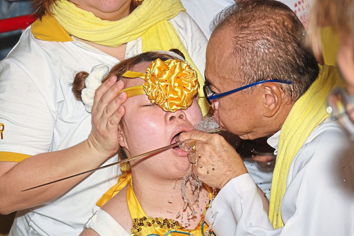 Ten bravely undergoing piercing during the procession to mark the last day of the festival.