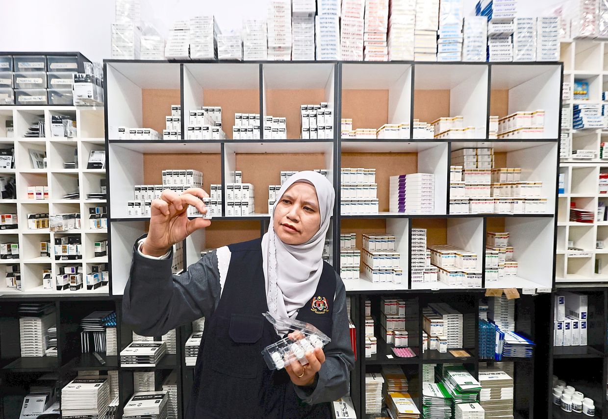 Cracking down: Dr Nur Sufiza Ahmad from the Selangor Health Department checking the products during a special operation in Bangi. — FAIHAN GHANI/The Star