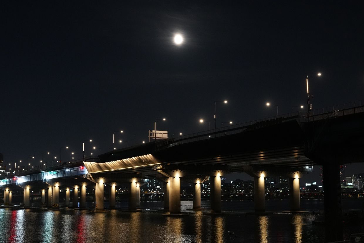 The super moon rises over a bridge in Seoul, South Korea, Wednesday, Nov. 5, 2025. -- AP Photo/Lee Jin-man