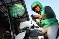 Grab Holdings raises full-year earnings forecast 