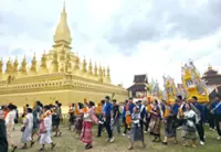 Wax castle parade a show of colour and devotion at That Luang festival in Laos