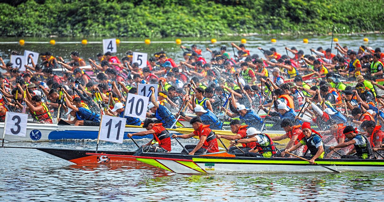 Paddlers from various teams surge forward in perfect synchronicity putting up a spectacular display of teamwork and determination at the regatta.