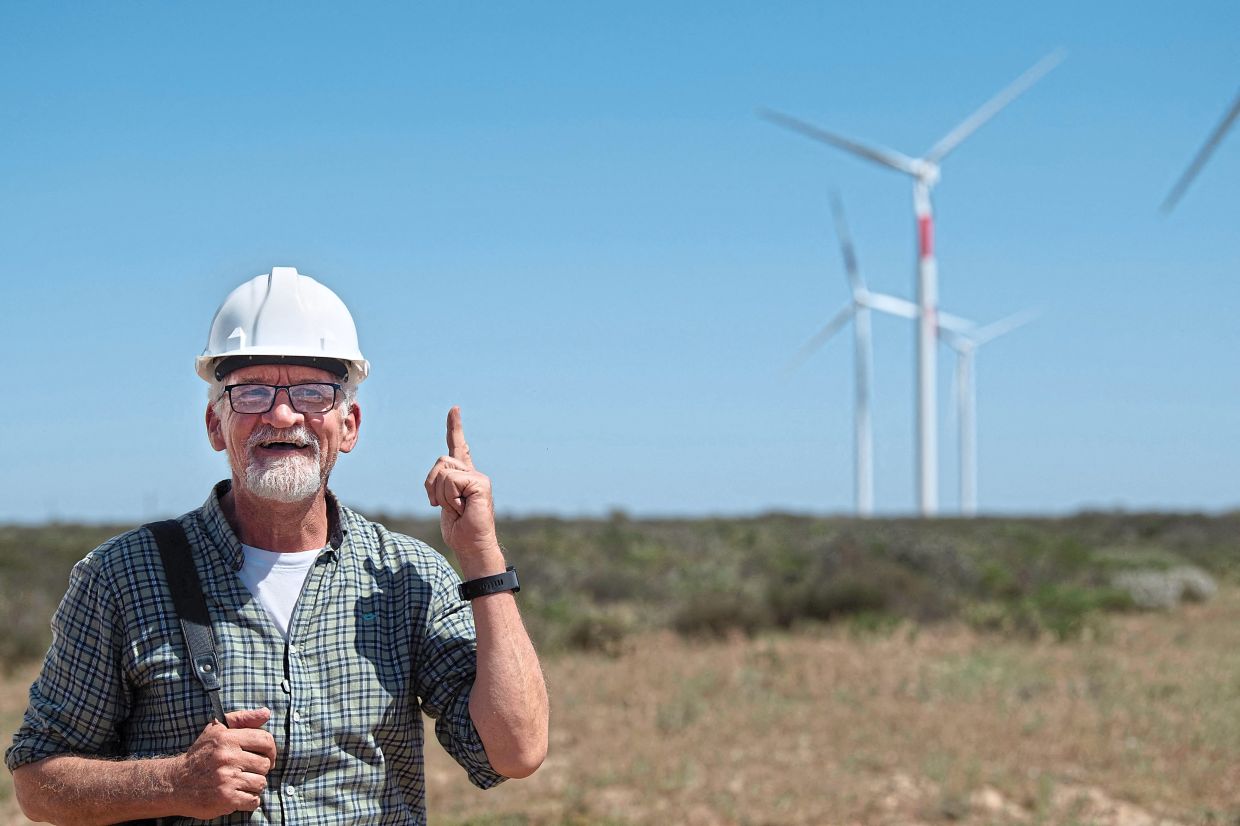 Simmons speaking about the project to paint wind turbines with red stripes to makes the blades more visible to birds to prevent bird-strikes, at Hopefield Wind Farm in Hopefield. — AFP 
