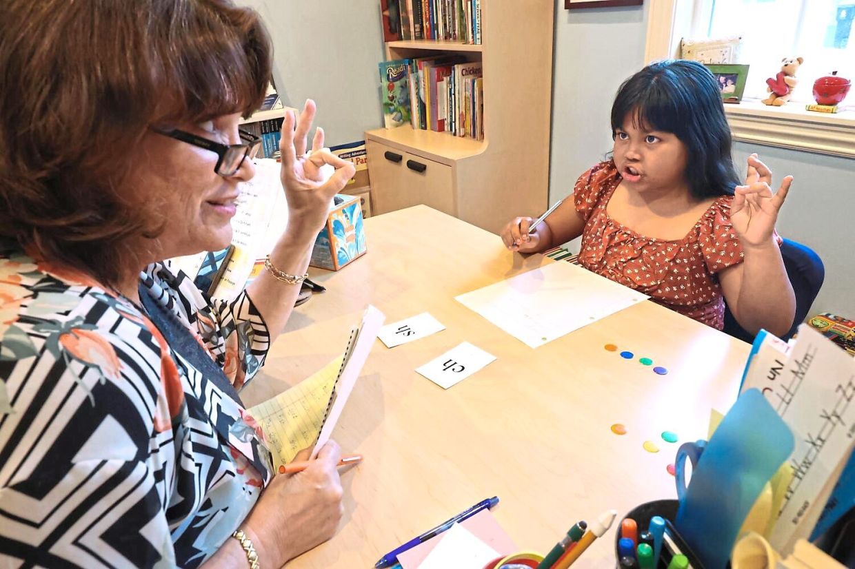 Private tutor Vanessa Silver, who helps young children struggling with dyslexia, works with Liina Yerro, on an enunciation exercise.