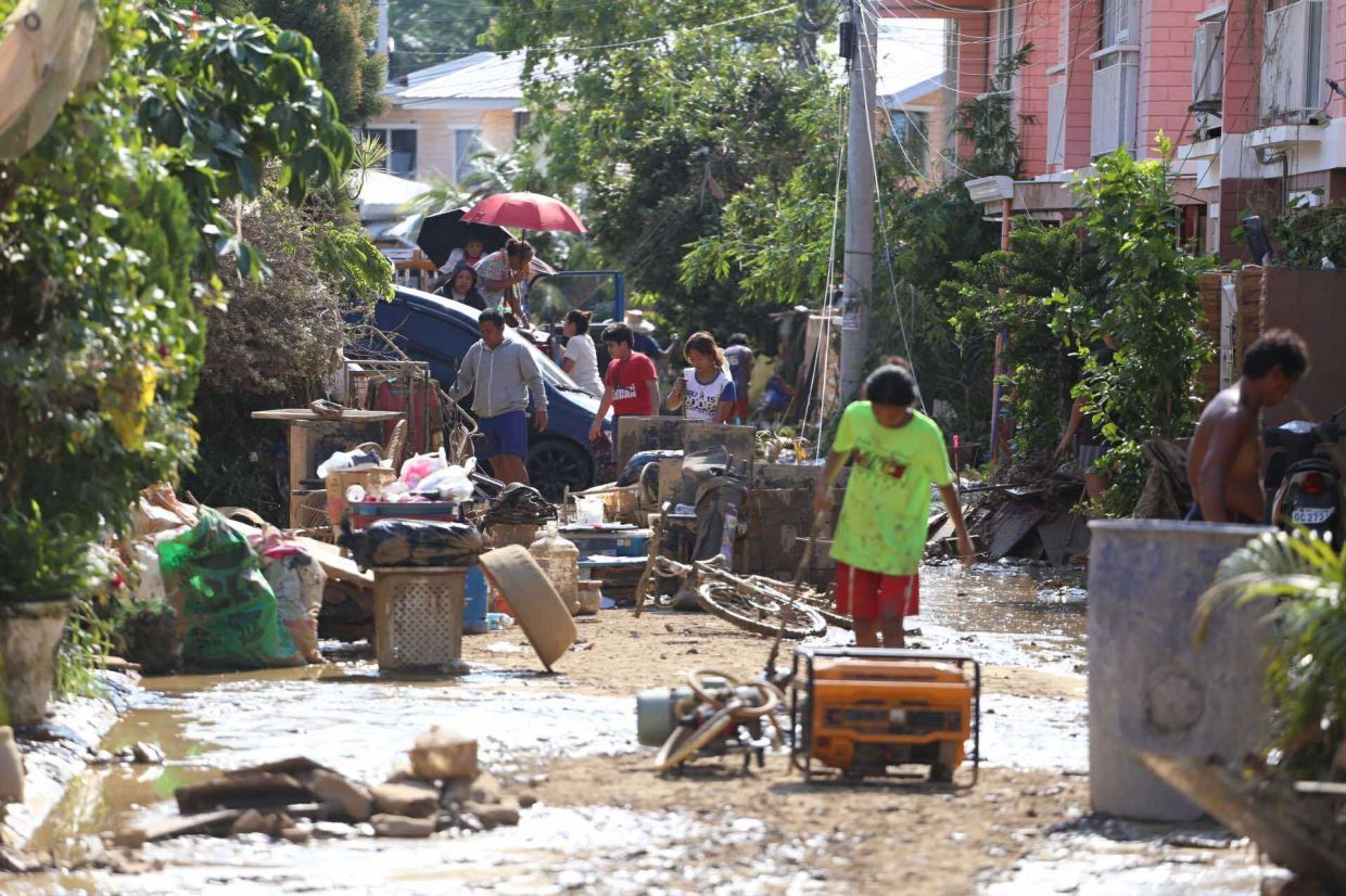 Residents clear their flood damaged homes caused by Typhoon Kalmaegi in Liloan, Cebu province, central Philippines on Thursday, Nov. 6, 2025. -- AP Photo/Jacqueline Hernandez