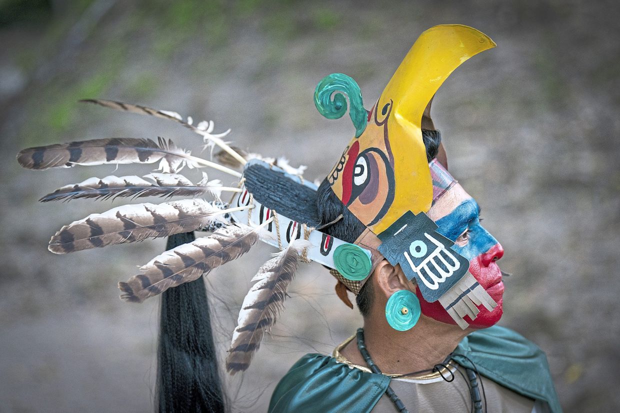 An example of indigenous costume at the Mayan ruins of Cahal Pech in Belize. — JANE BARLOW/PA Wire/dpa