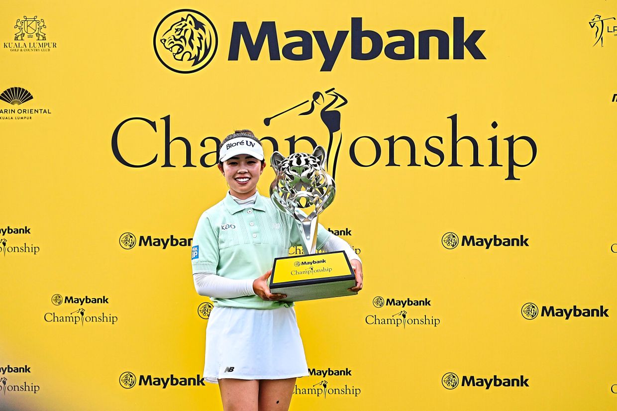 Winning smile: Yamashita posing with her trophy after her LPGA win at the Maybank Championship at the KLGCC. — IZZRAFIQ ALIAS/The Star