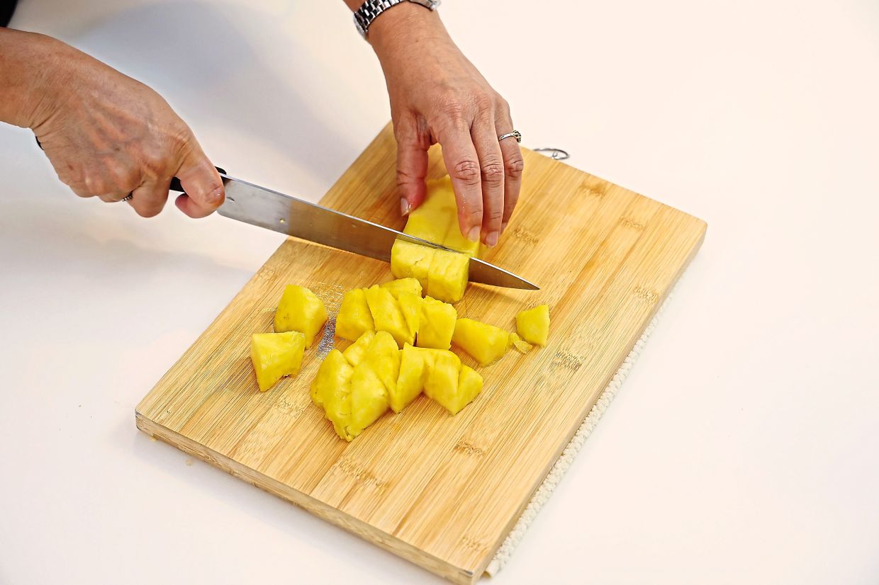 Cut the pineapple into bite-sized cubes.