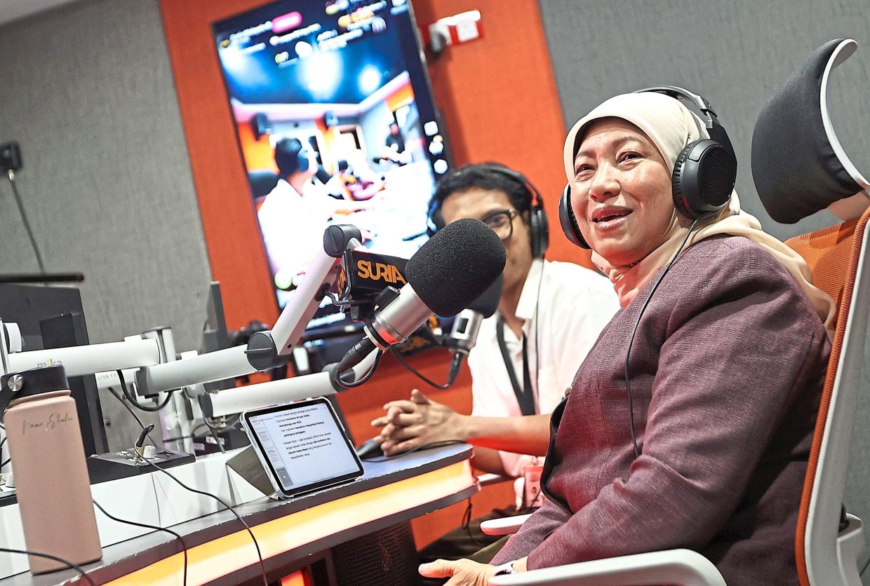 Nancy explaining on air at Suria FM how the nation is preparing caregivers for Malaysia and the Asean region, as part of the CARECON2025 initiatives. — AZMAN GHANI/ The Star