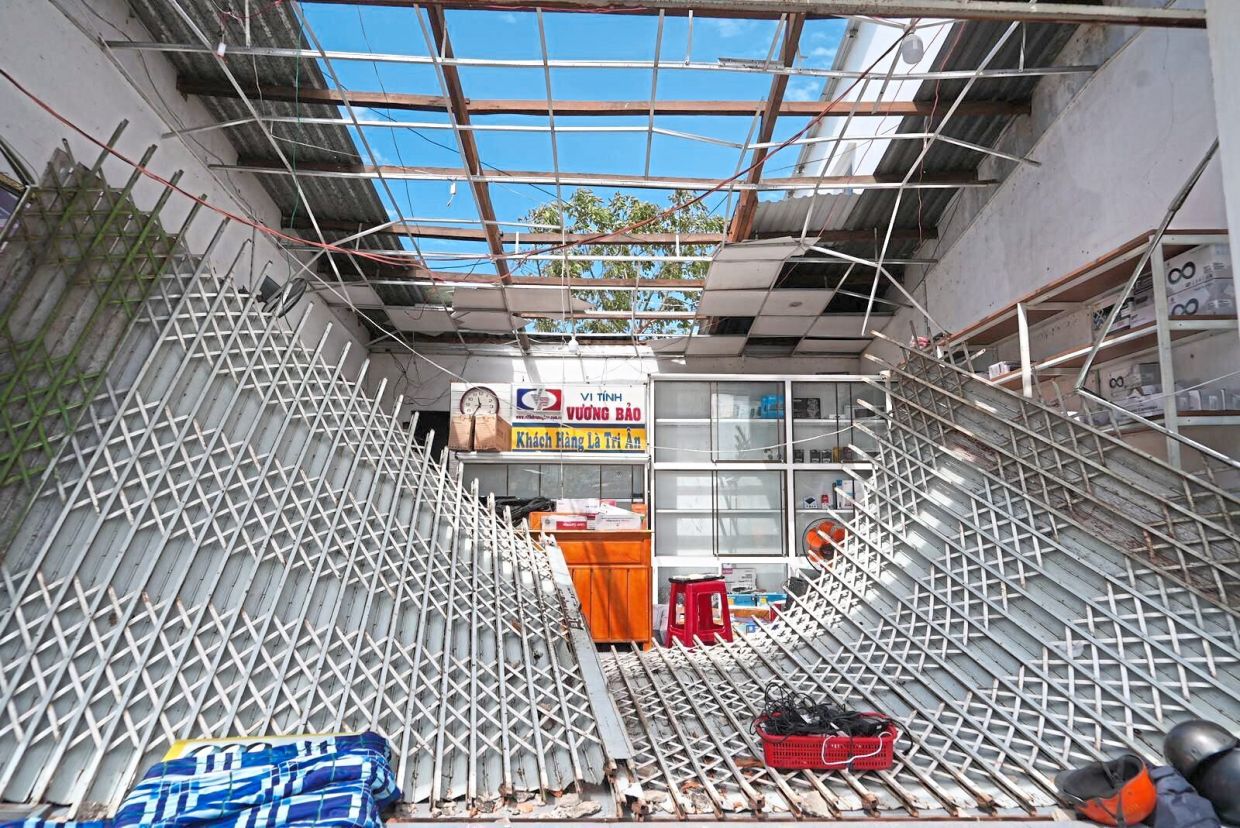 Aftermath: A damaged roof and entrance are seen in Dak Lak. — AP