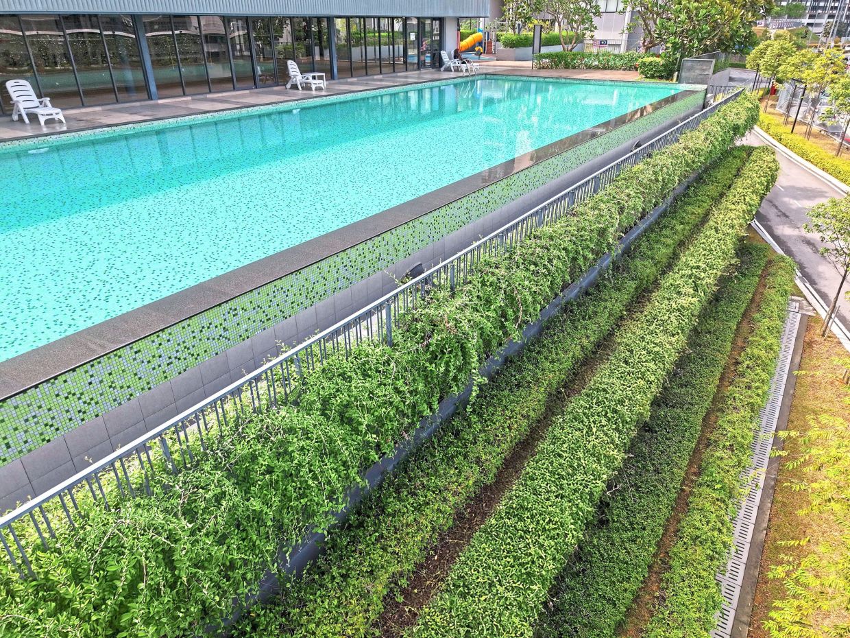 Multi-tiered shrubbery frames the infinity pool reminiscent of the hanging gardens of Babylon.