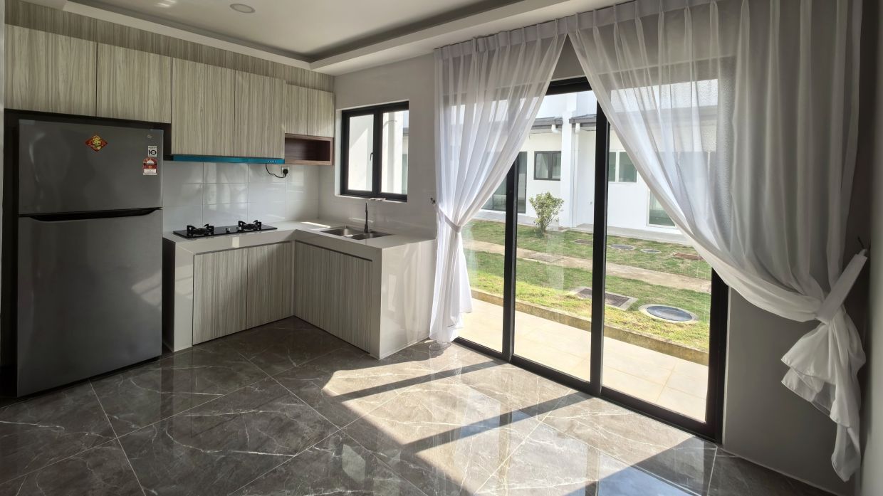 Natural light fills the kitchen, forming the home's central hub while embodying M10 Residency's energy-saving design.