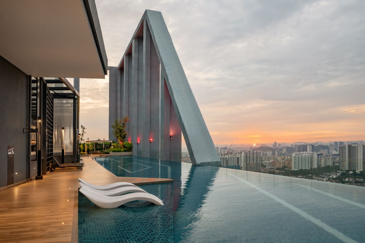 A rooftop infinity pool overlooking the skyline, framed by one of the tallest crowns.