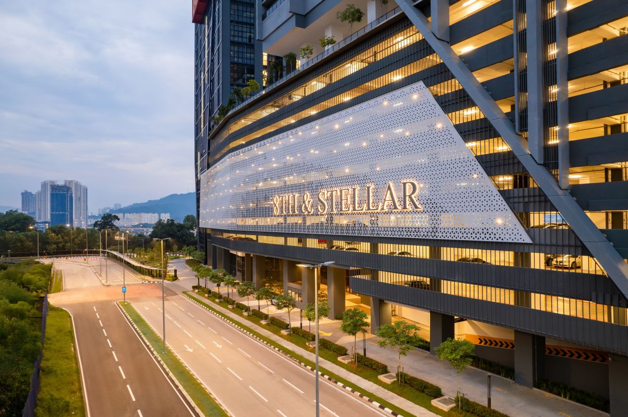 An illuminated facade featuring celestial-inspired patterns that glow against the cityscape.