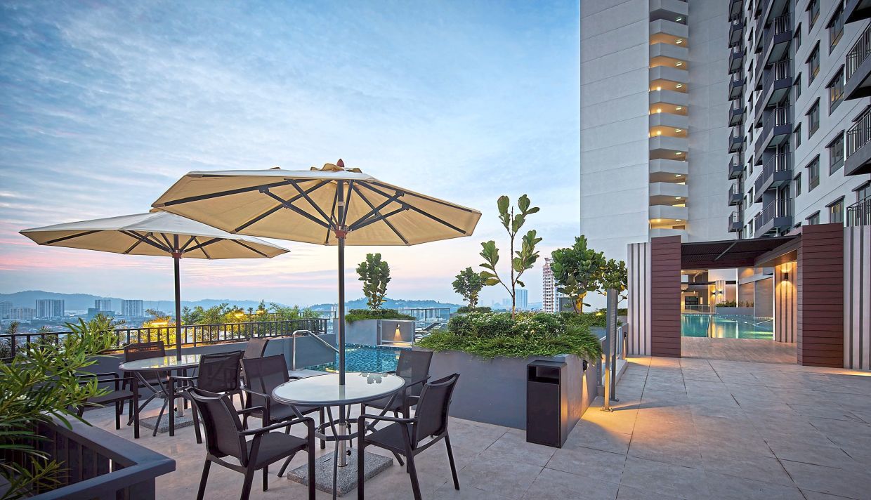 Poolside seating (above) provides a serene spot to chill and chat while the well-equipped gym (below) fosters a healthy lifestyle for the community.