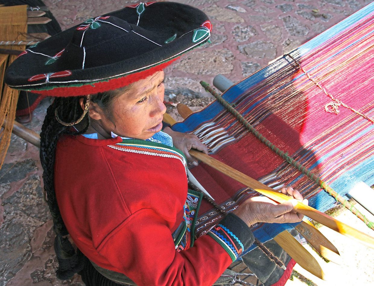 A woman with a traditional back-strap loom in Chinchero.
