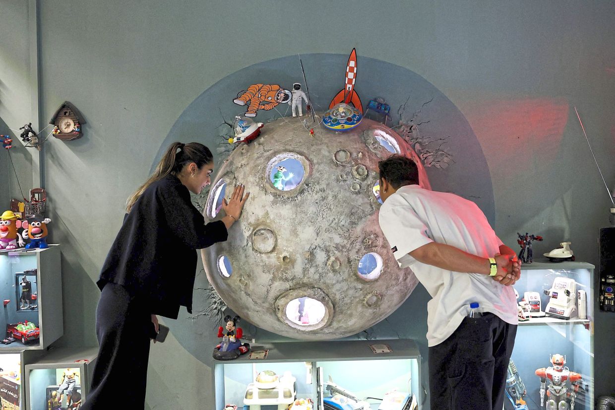 Visitors look at Tintin items displayed at the toy museum in Tehran.