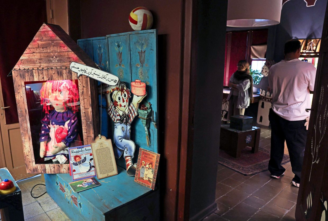 Visitors look at items displayed at a toy museum in the Iranian capital Tehran on October 26, 2025. (Photo by AFP)