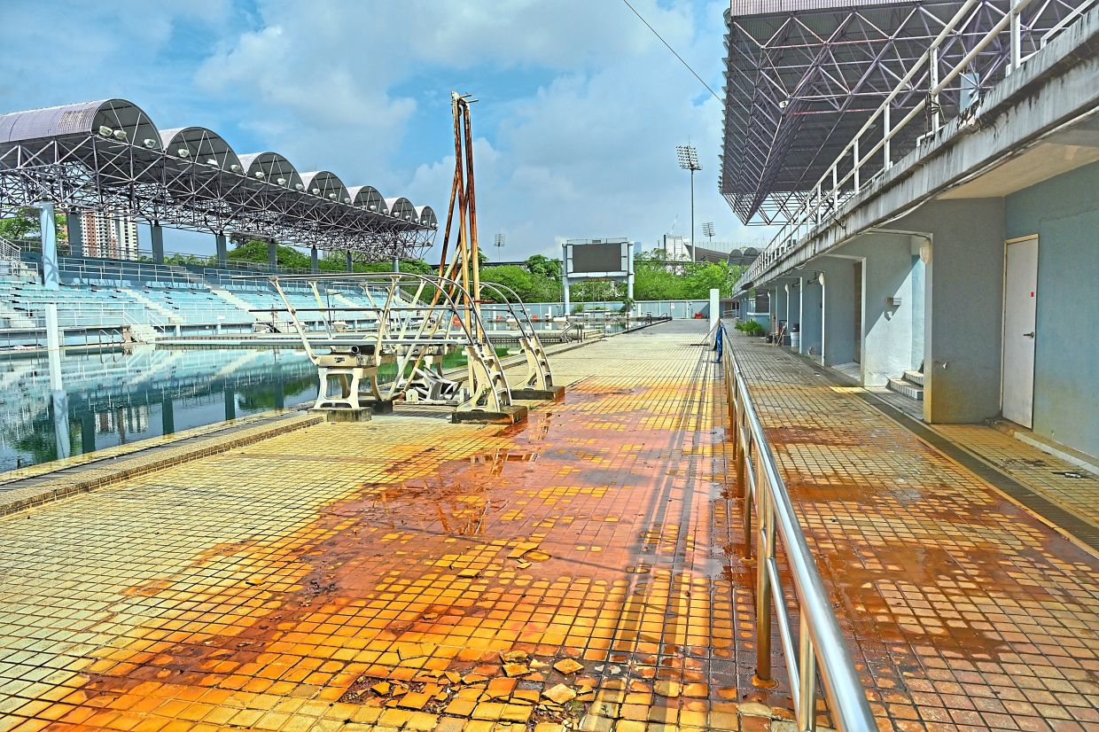 Rust stains and cracked tiles line the deck of the complex.