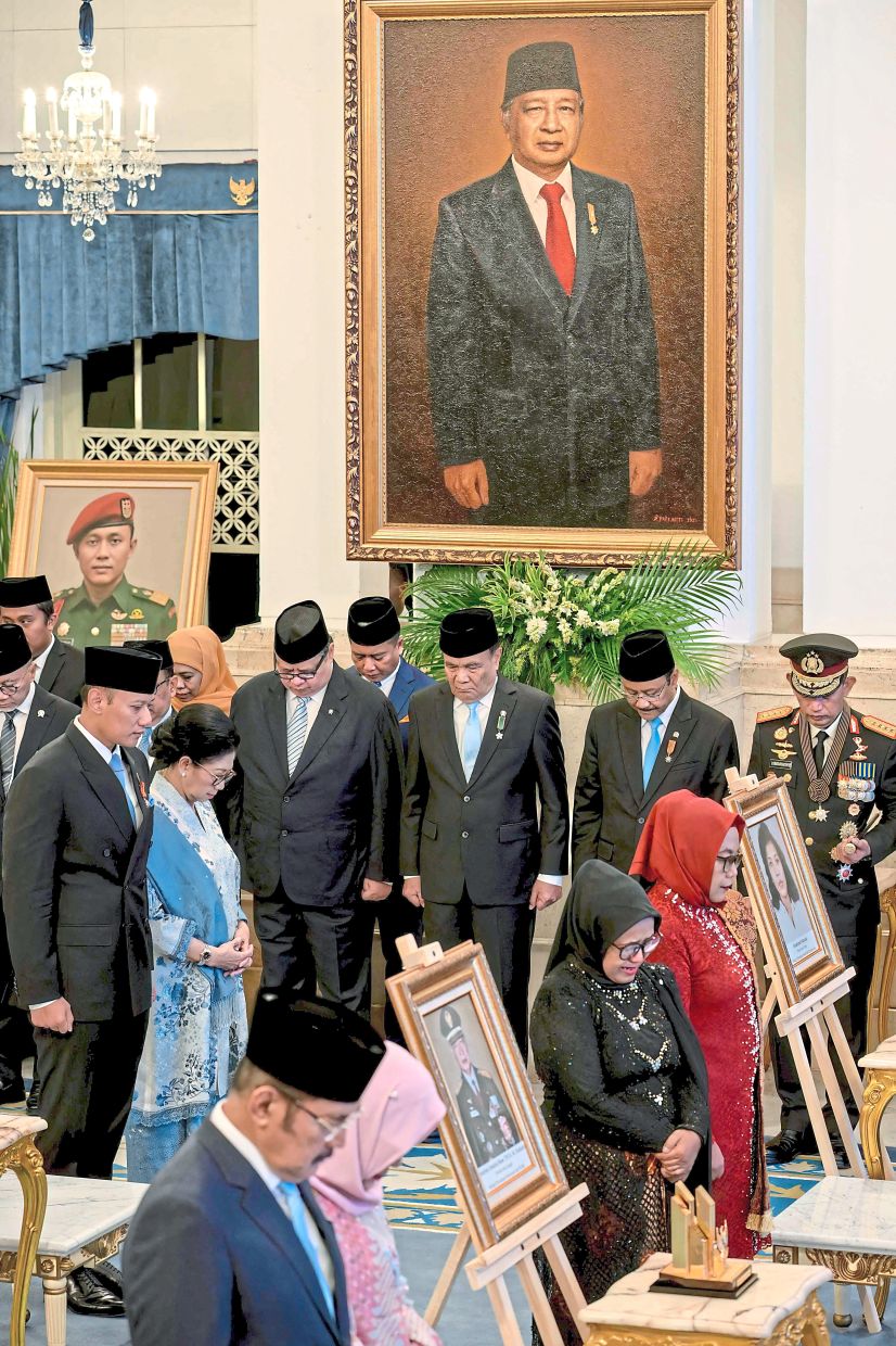 National heroes: A portrait of Suharto is displayed during the ceremony honouring this year’s heroes at the Merdeka Palace in Jakarta. — AFP