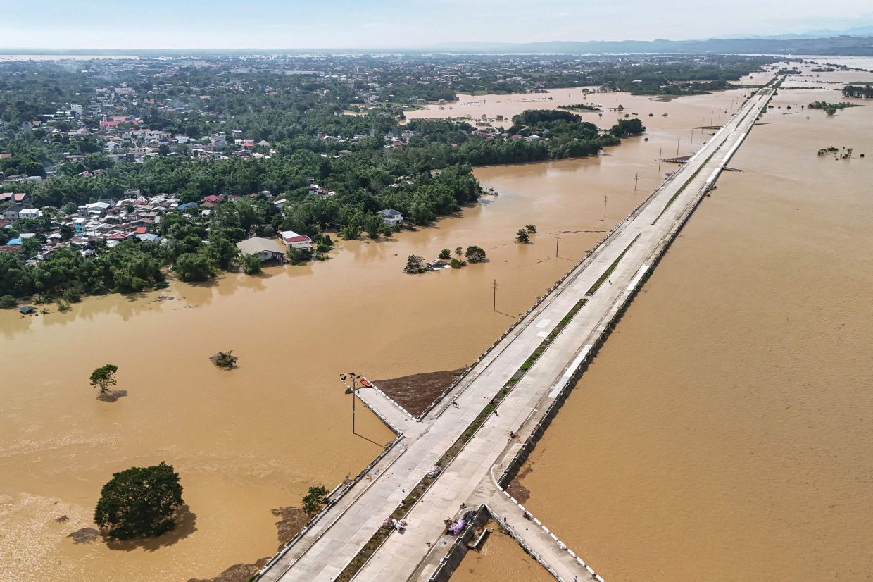 An aerial view of a submerged under construction road in Tuguegarao Citycon Nov 11, 2025, as flood waters continue to inundate homes due to heavy rains brought about by Super Typhoon Fung-wong. - AFP