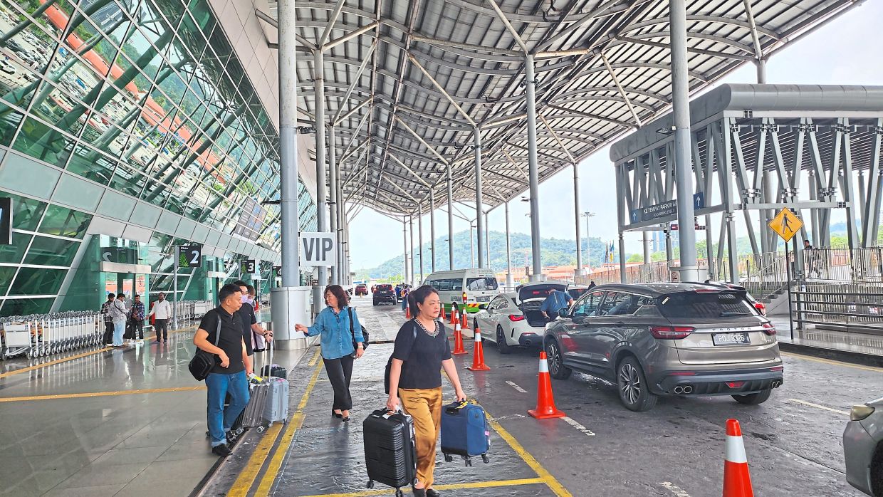 Travellers outside the departure hall at PIA.